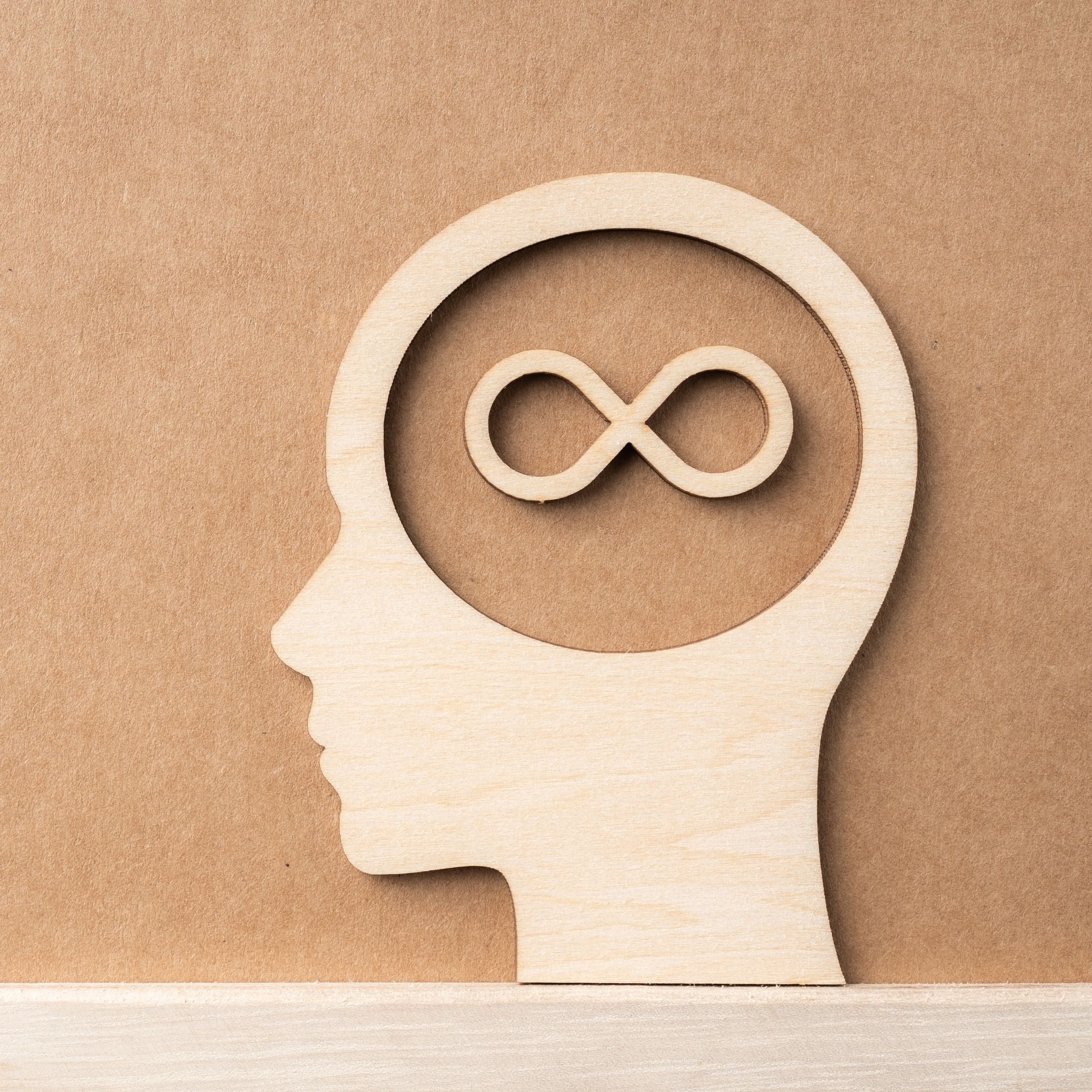 Photo of an artistic design of wood art of a face and infinity symbol within the headspace