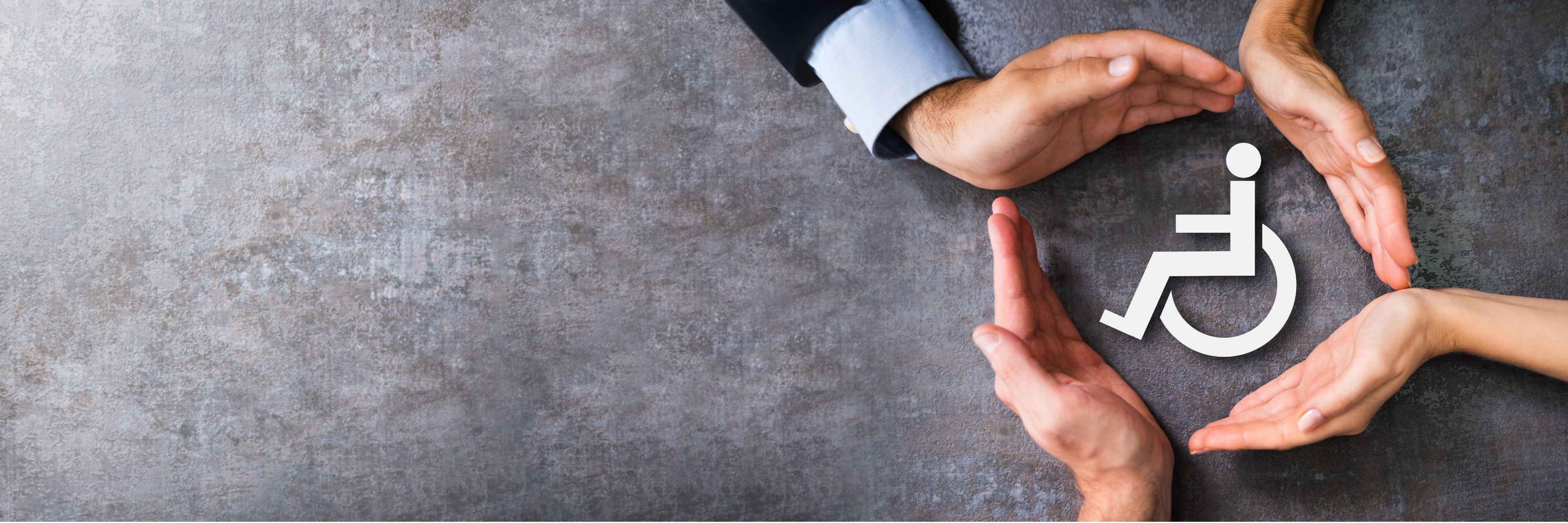 Hands forming a circle around a wheelchair accessibility icon on a gray background