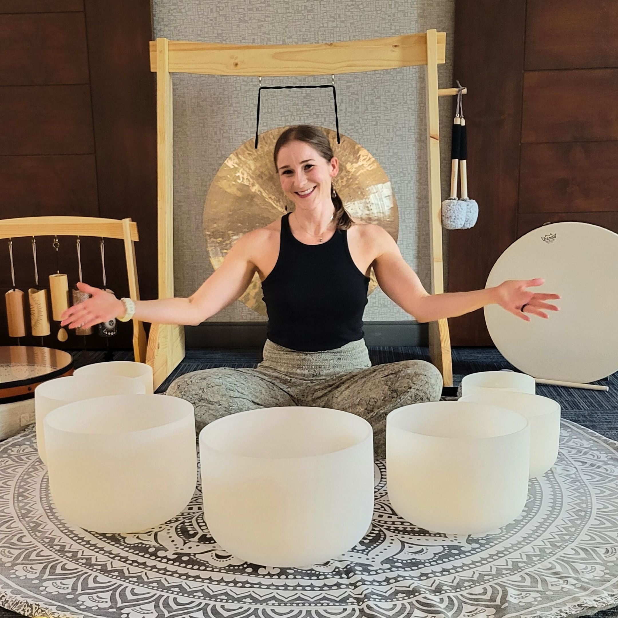 Ascendify Wellness Founder, Liz Adriano, welcoming guests surrounded by her sound meditation instruments