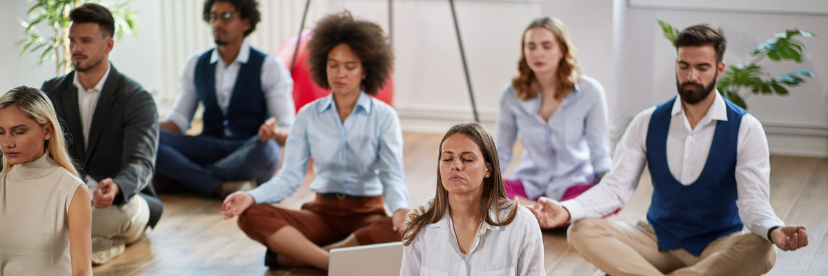 Corporate team meditating in an executive workshop.