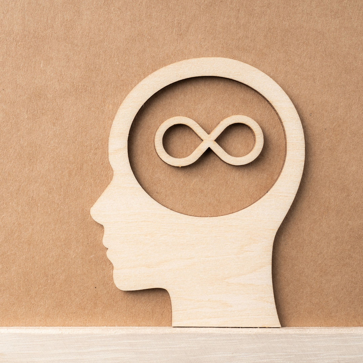 Photo of an artistic design of wood art of a face and infinity symbol within the headspace