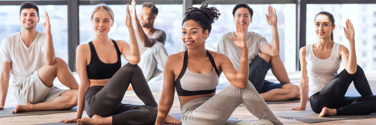 Group of people practicing yoga in an office lobby setting