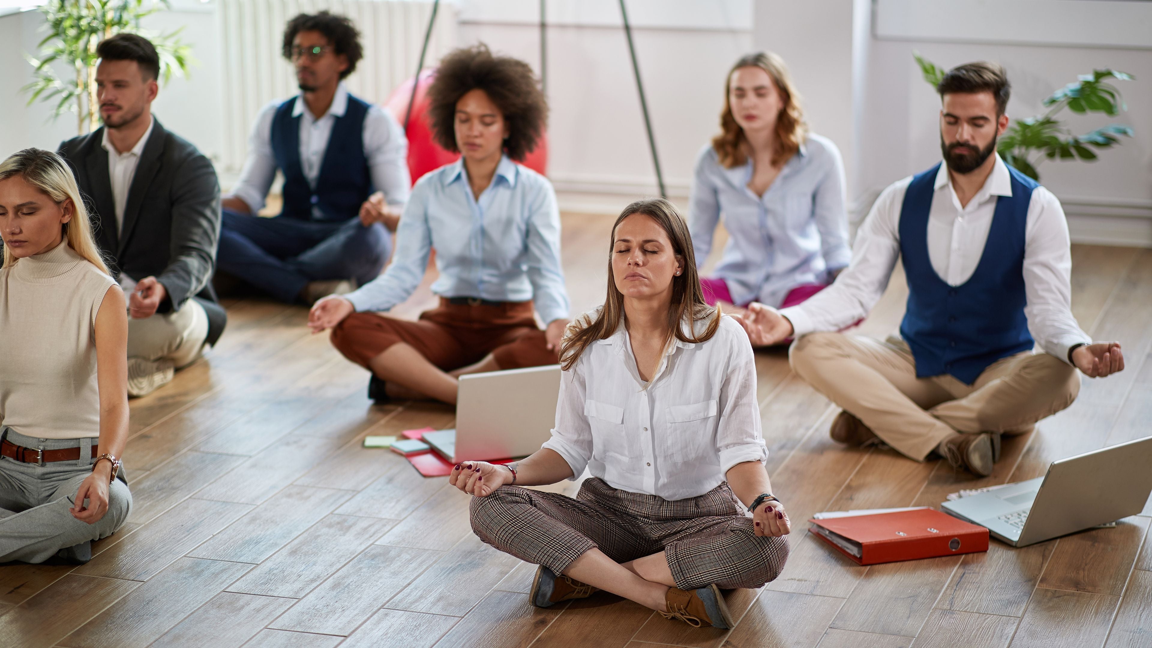 Group of professionals enjoying a meditation in the office